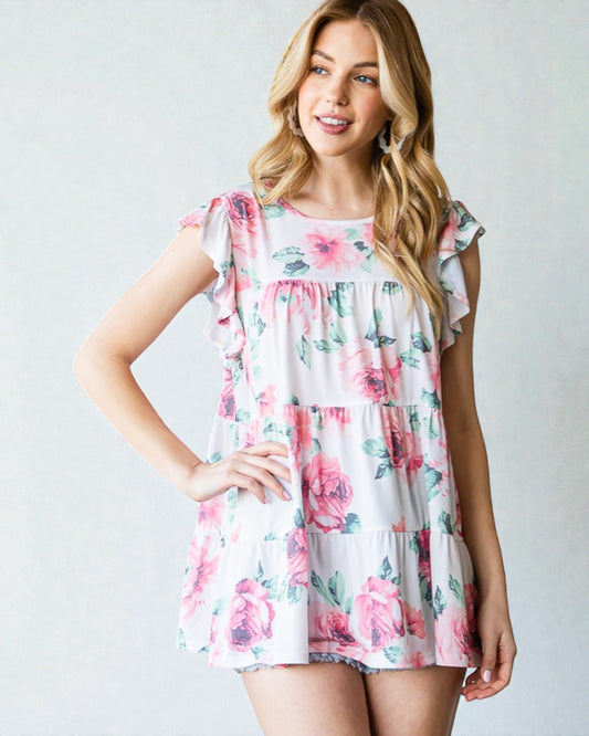 Woman wearing a floral dress against a plain background