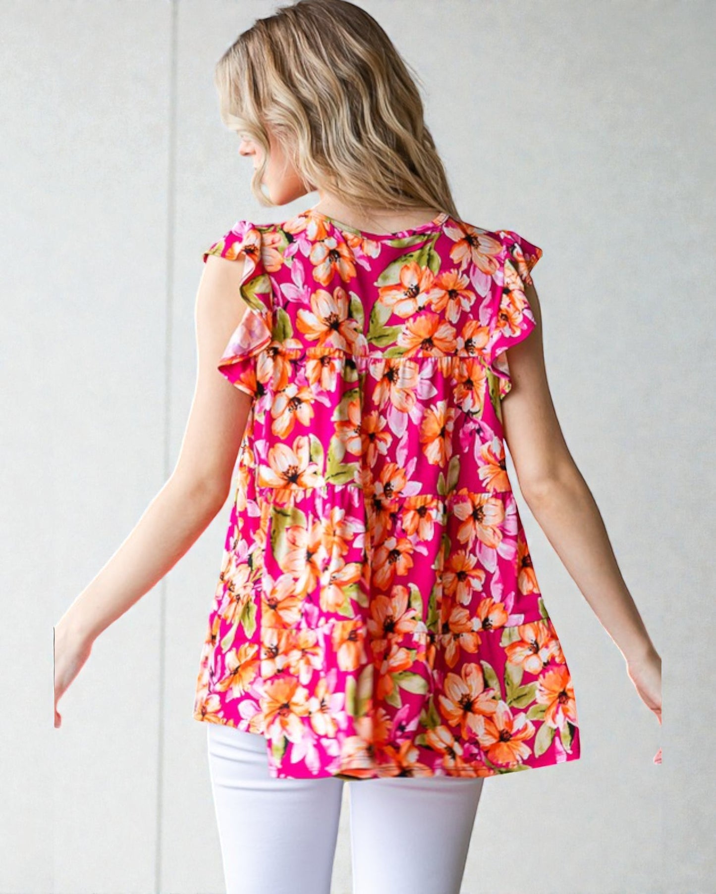 Woman wearing a pink floral top against a white background