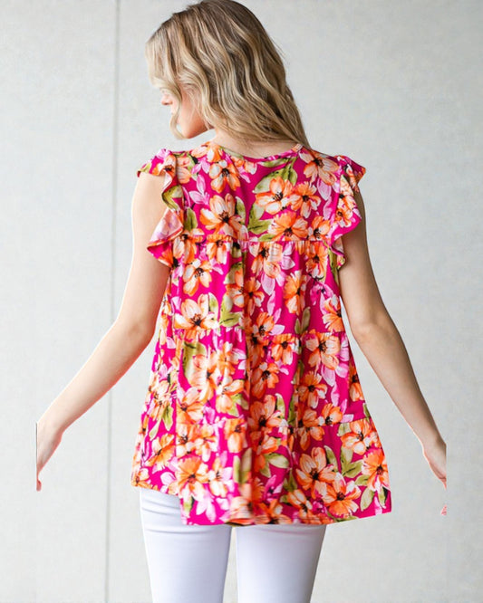 Woman wearing a pink floral top against a white background
