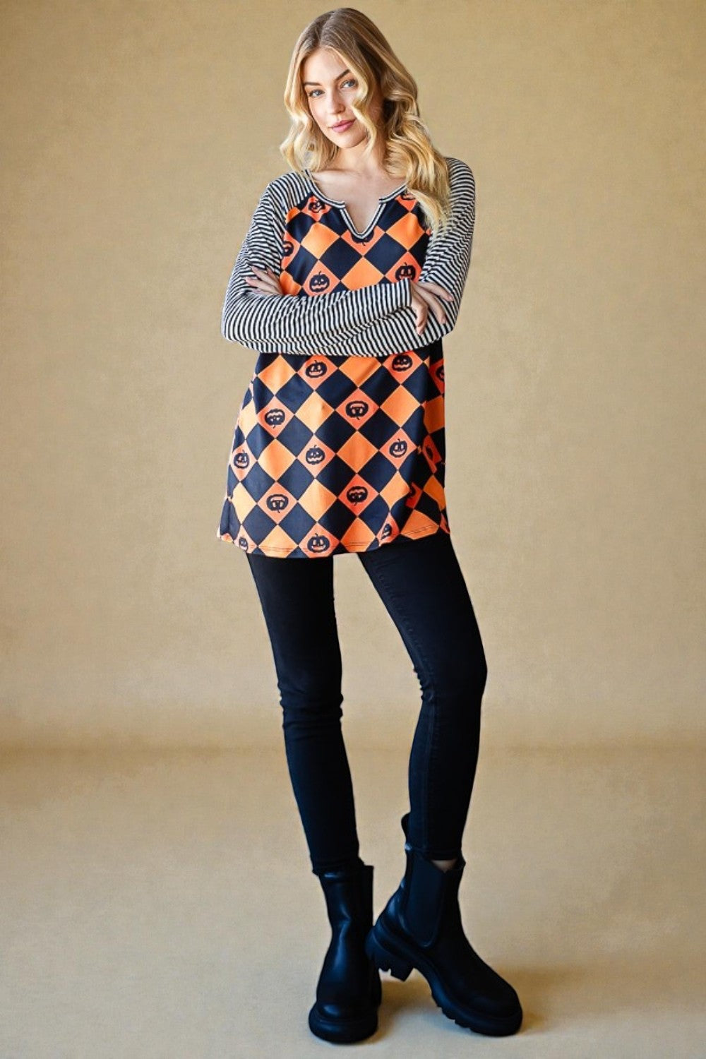 Woman wearing a checkered dress with orange and black pattern on a beige background
