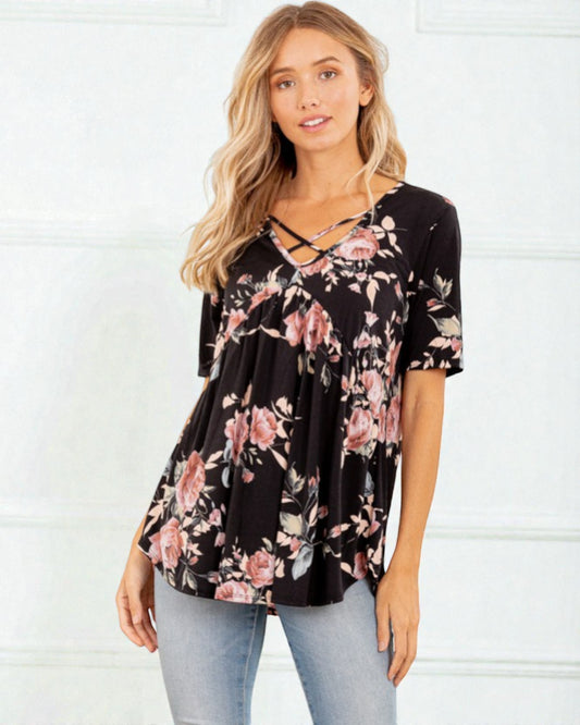 Woman wearing a black floral top against a white background