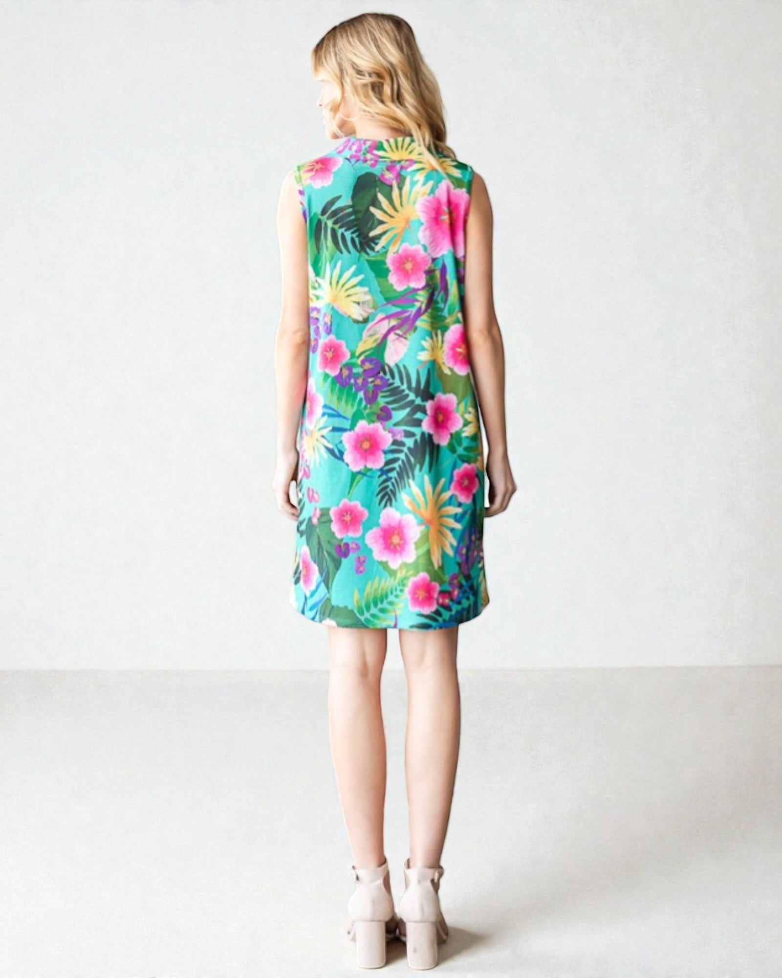 Woman wearing a colorful floral dress on a white background