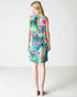 Woman wearing a colorful floral dress on a white background