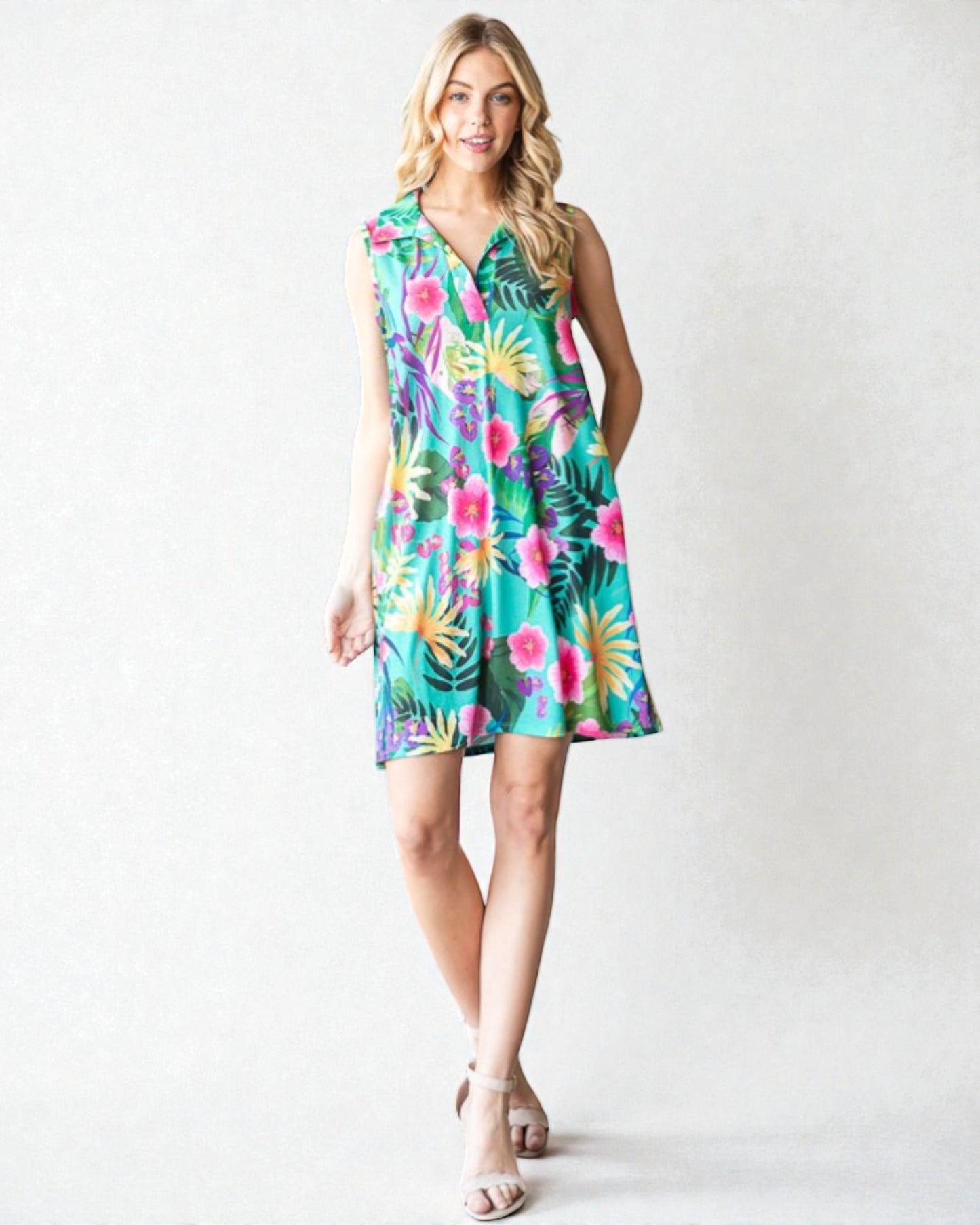 Woman wearing a colorful floral dress on a white background