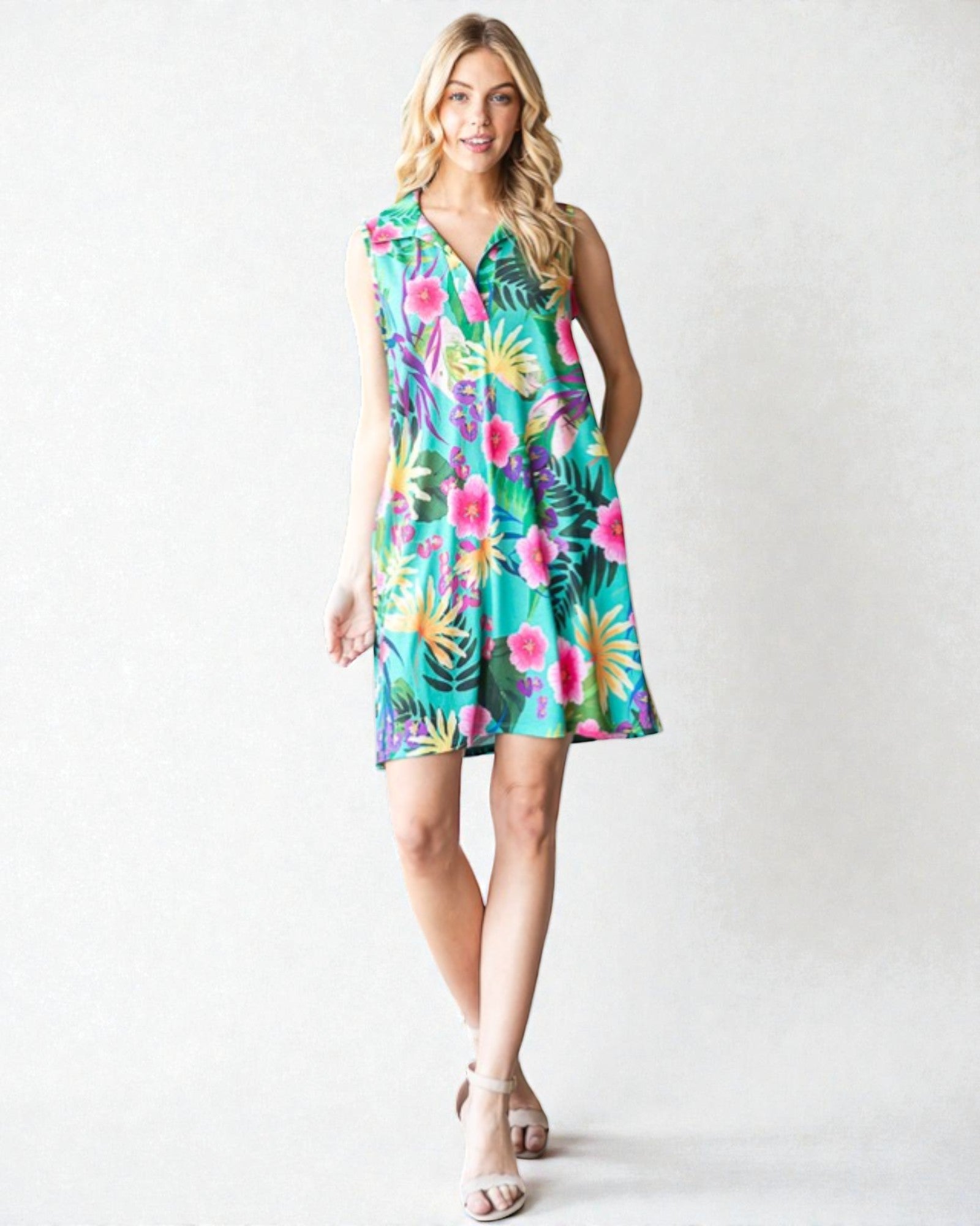 Woman wearing a colorful floral dress on a white background