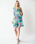 Woman wearing a colorful floral dress on a white background