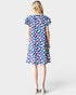Woman wearing a colorful floral dress on a white background