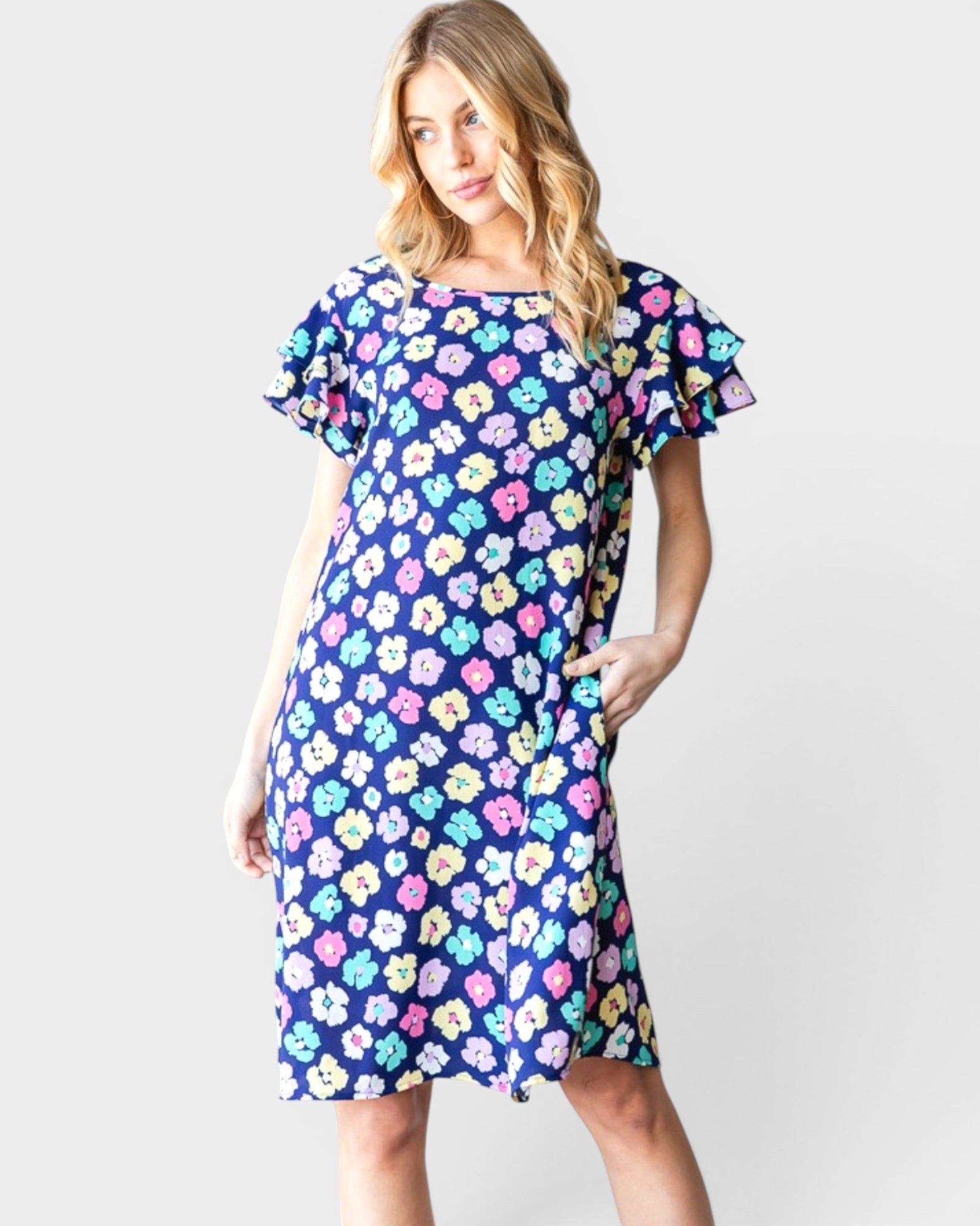 Woman wearing a colorful floral dress on a white background