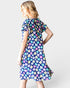 Woman wearing a floral dress on a white background