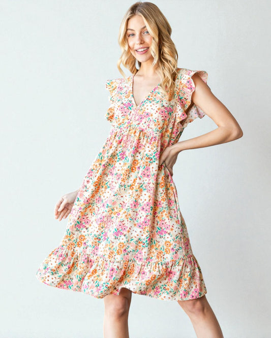 Woman wearing a floral dress on a plain background