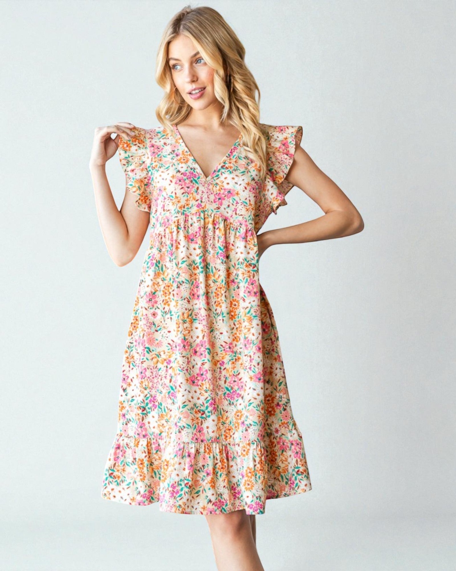 Woman wearing a floral dress on a light gray background