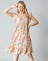 Woman wearing a floral dress against a plain background