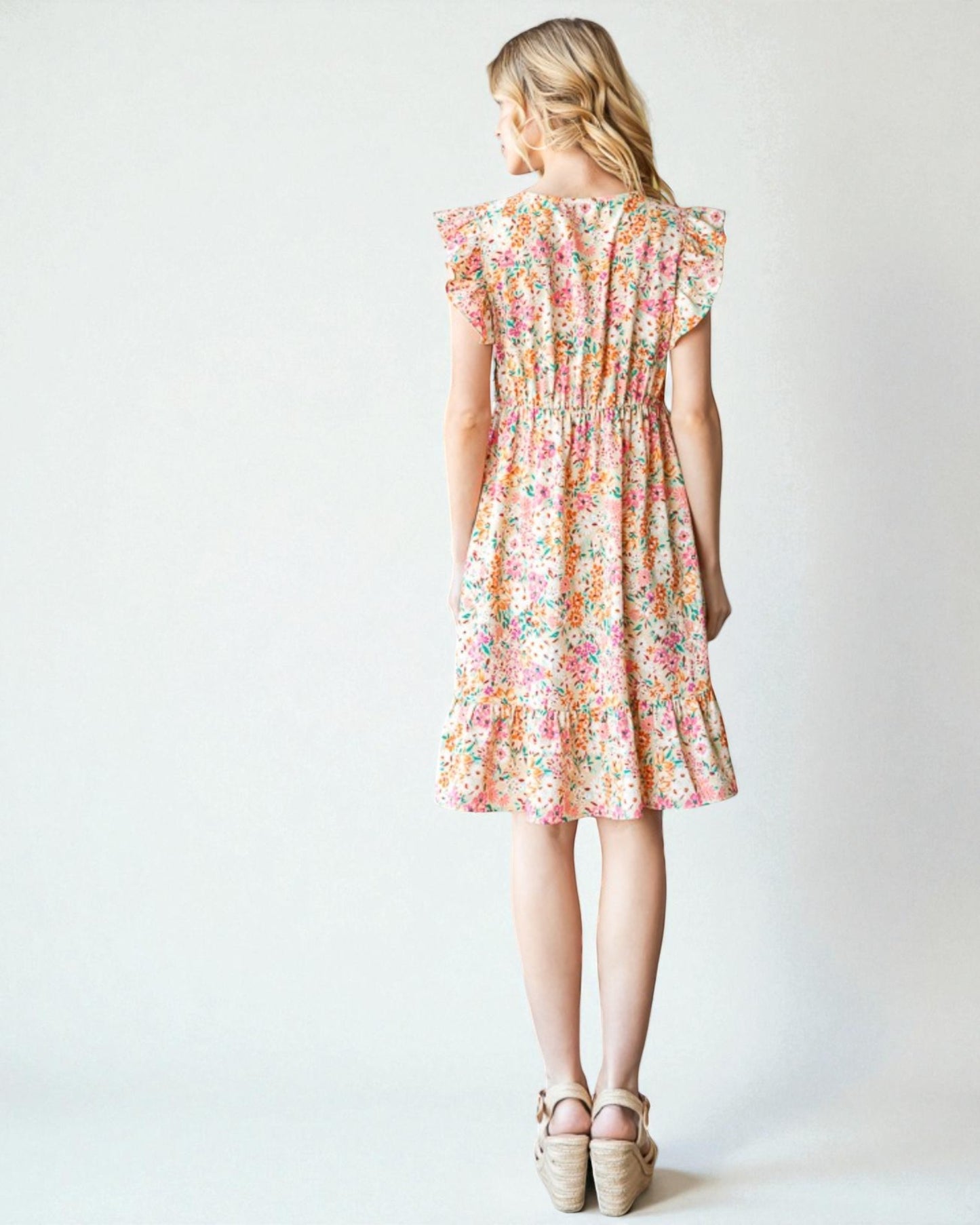 Woman wearing a floral dress on a white background