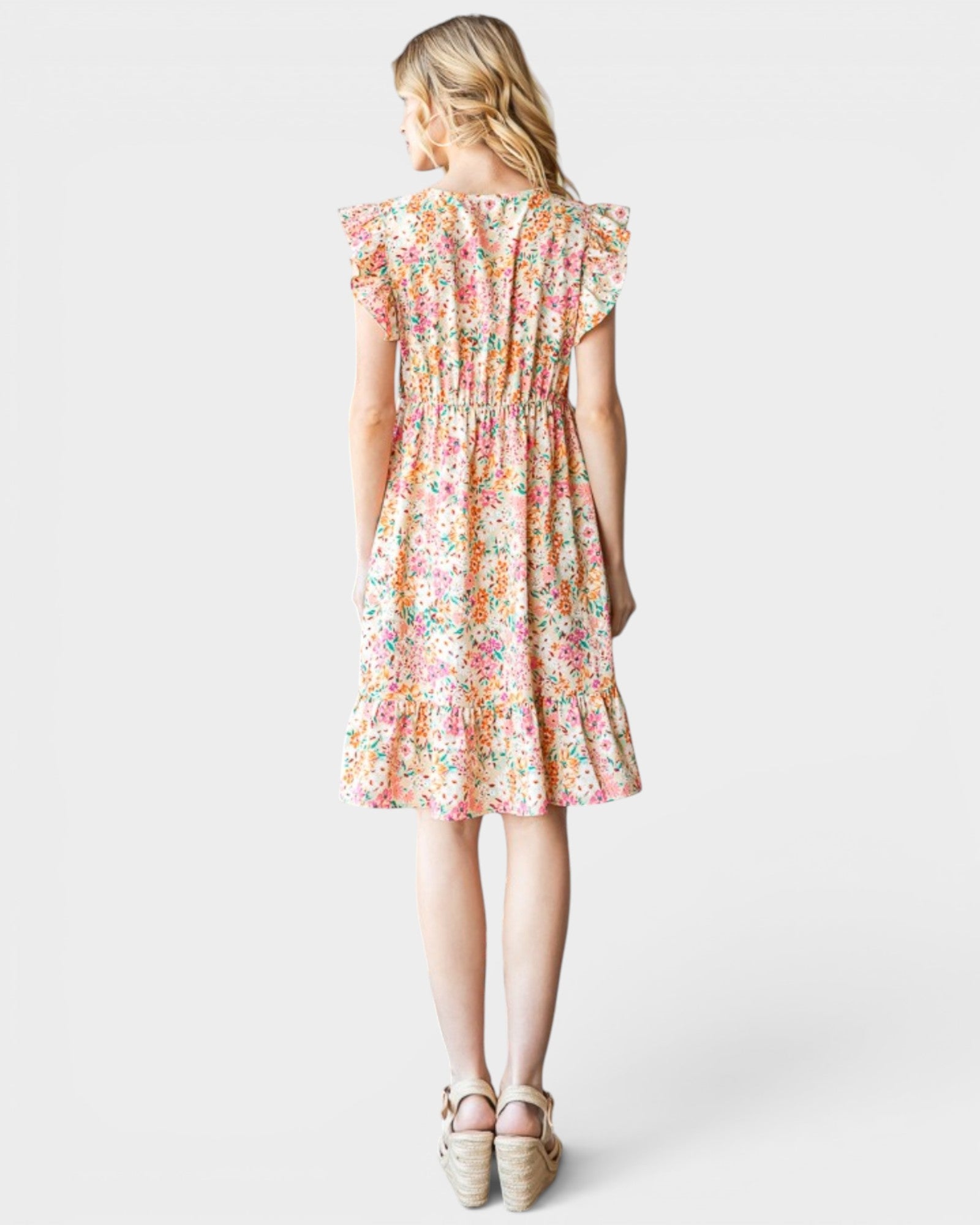 Woman wearing a floral dress on a white background