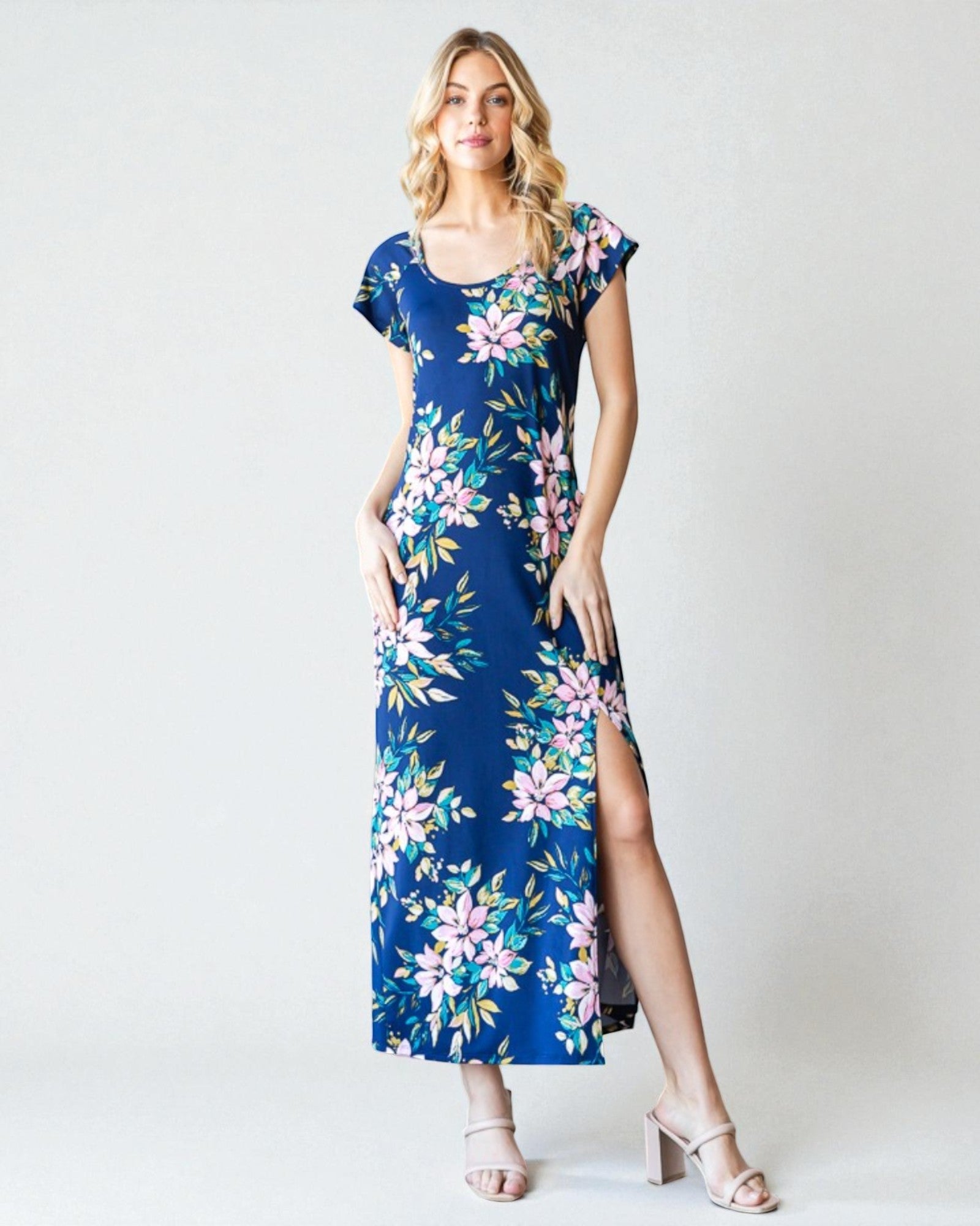 Woman wearing a blue floral dress against a white background