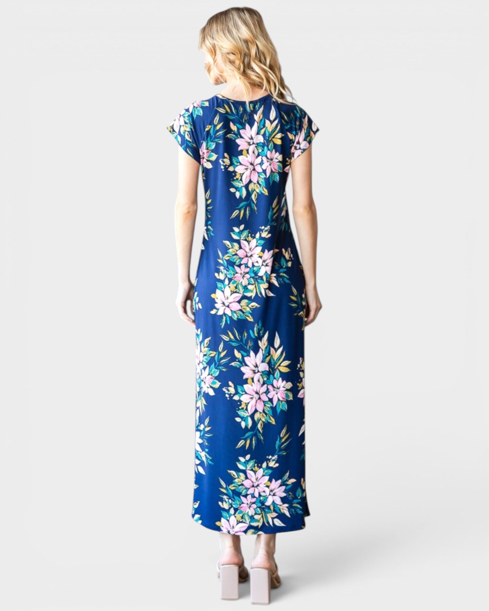 Woman wearing a blue floral dress on a white background