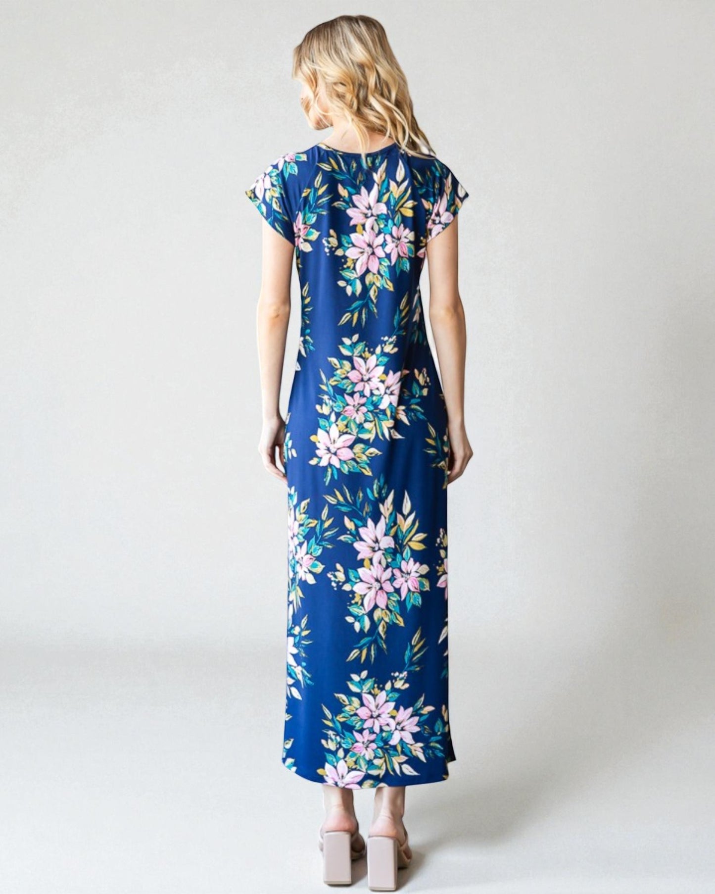 Woman wearing a blue floral dress on a white background