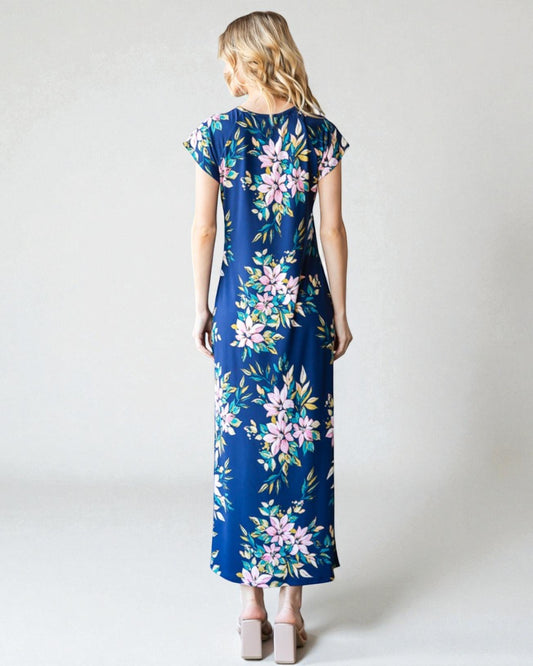 Woman wearing a blue floral dress on a white background