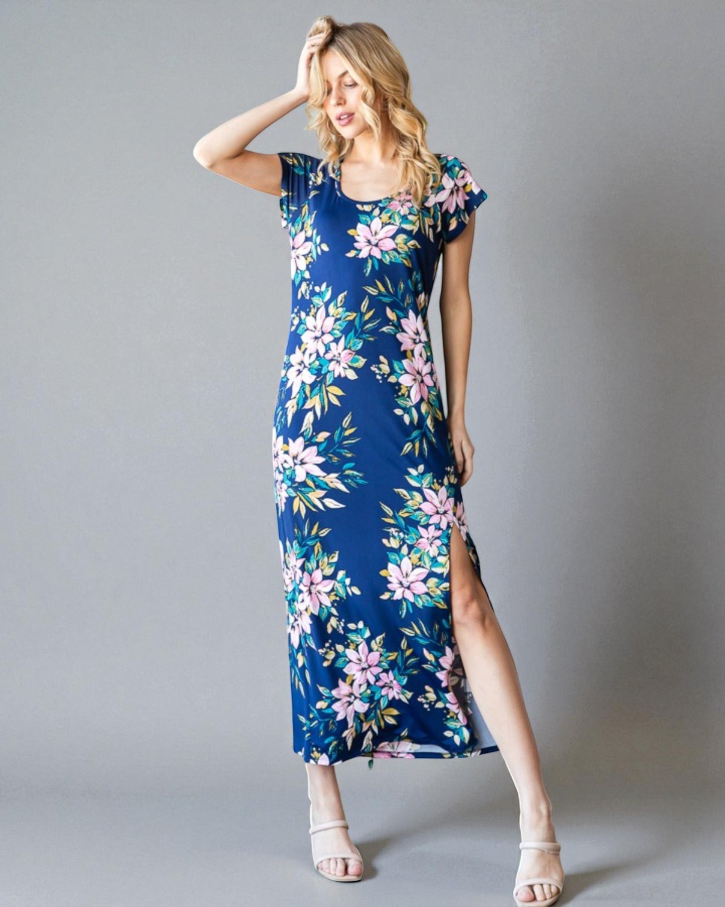 Woman wearing a blue floral dress on a gray background