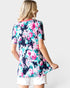 Woman wearing a floral dress with a white background