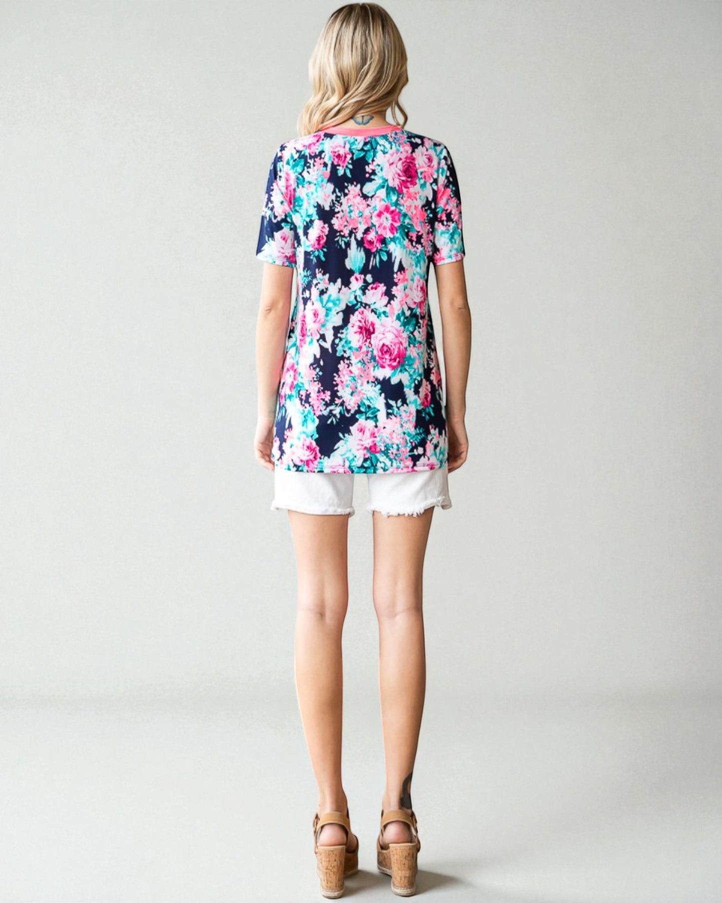 Woman wearing a floral dress with a plain background