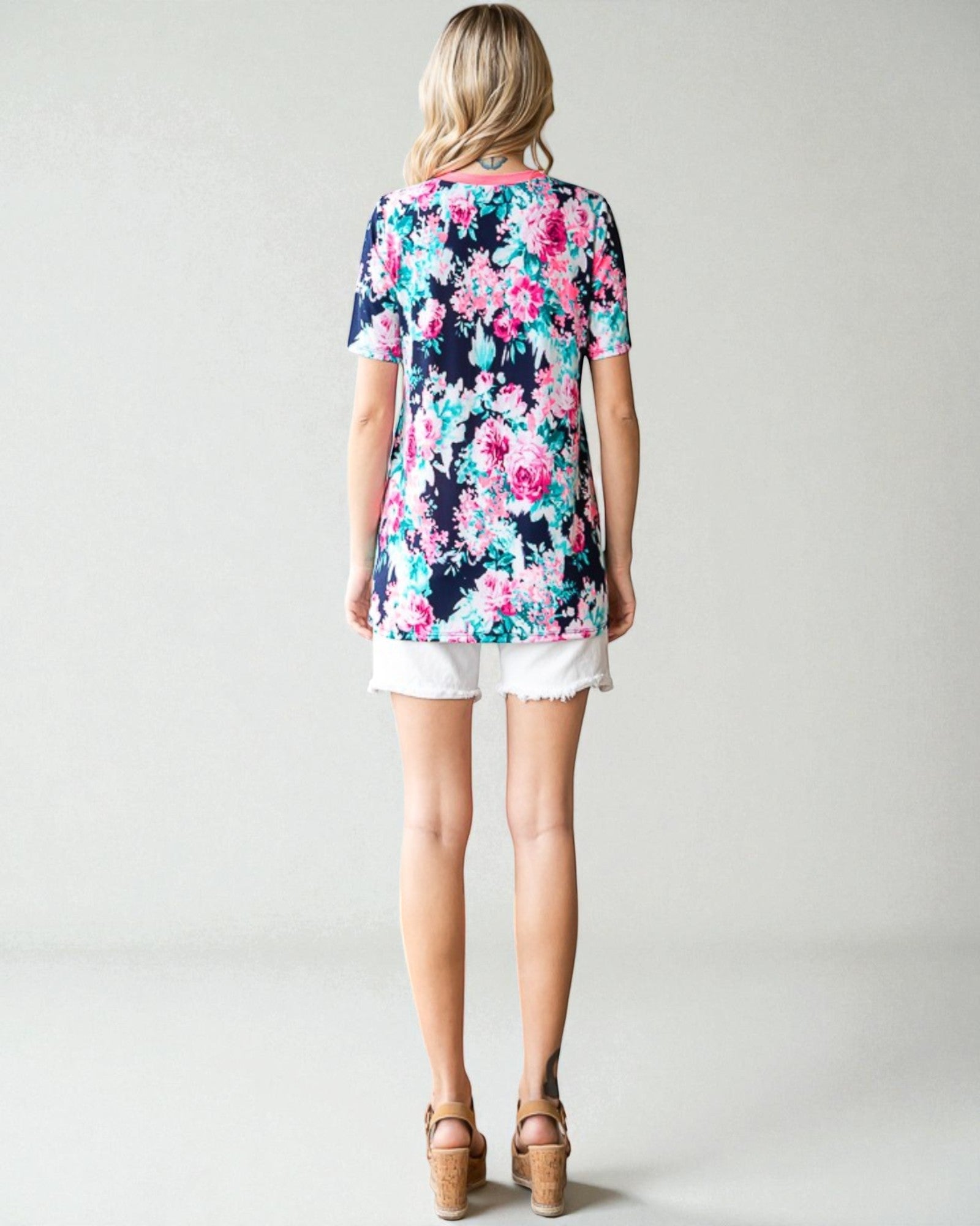 Woman wearing a floral dress with a plain background