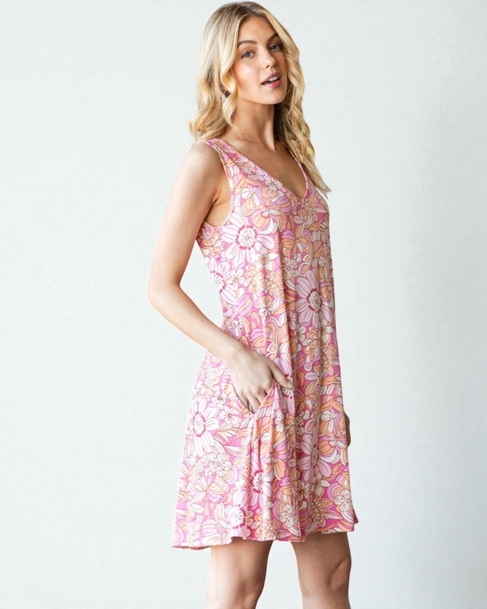 Woman wearing a pink floral dress on a white background