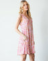Woman wearing a pink floral dress on a white background