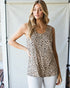 Woman wearing a leopard print tank top against a neutral background