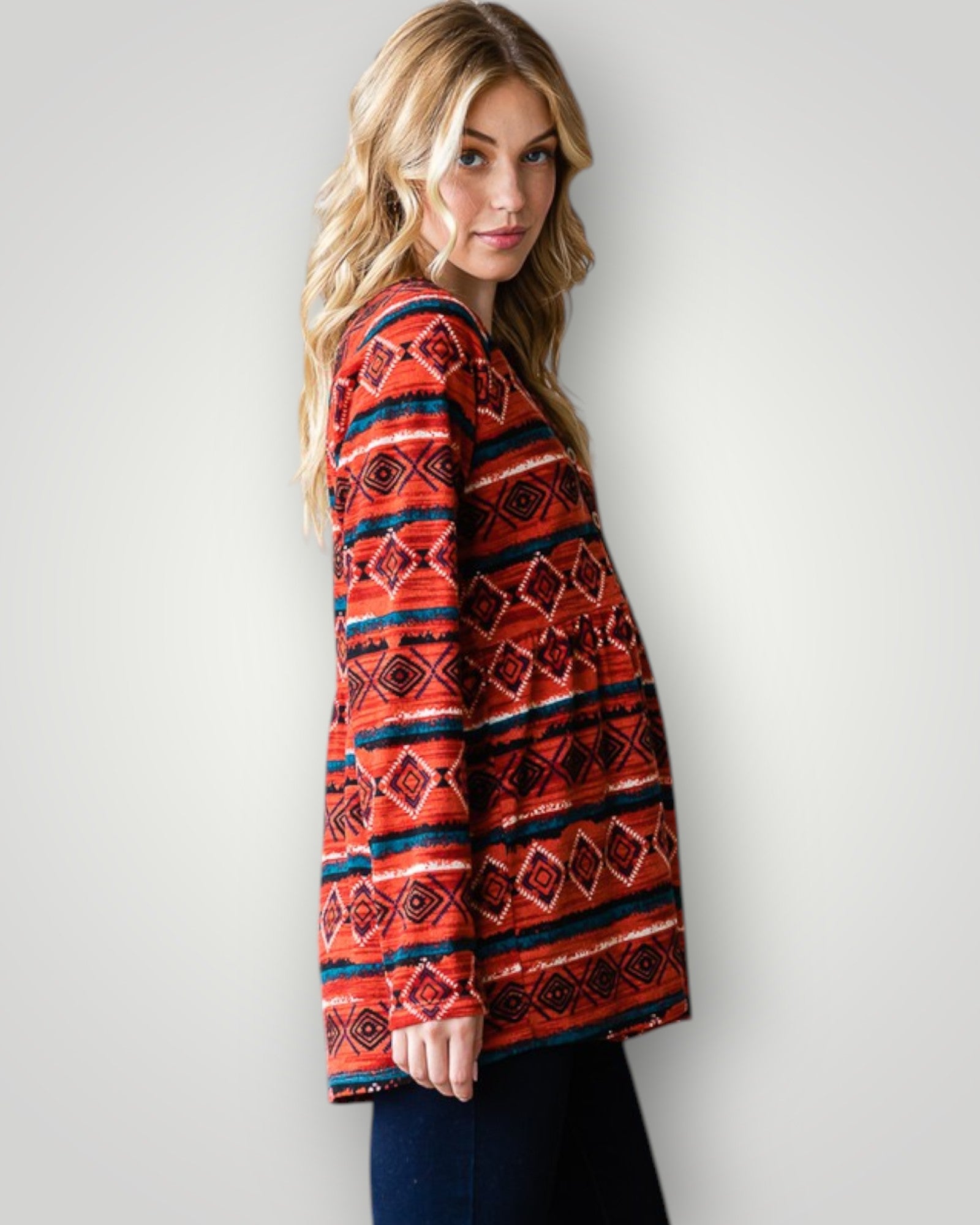 Woman wearing a red patterned sweater against a white background
