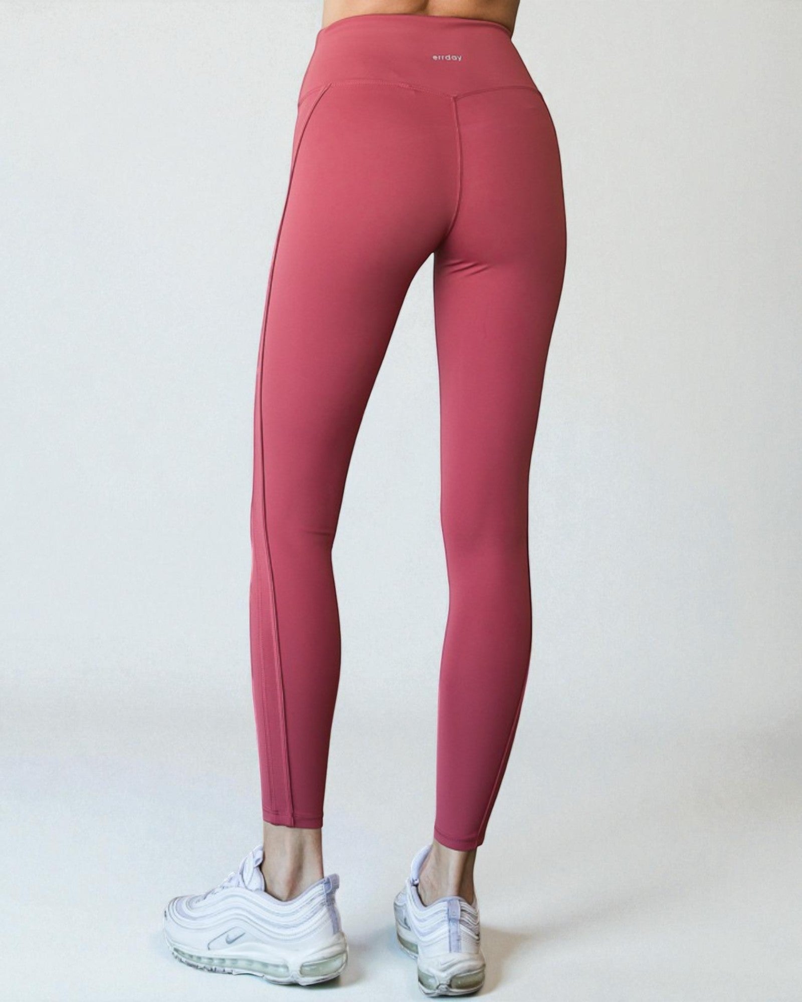 Pink leggings worn by a person on a white background