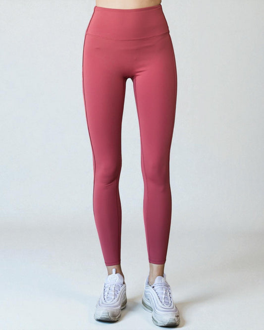 Person wearing pink leggings on a white background