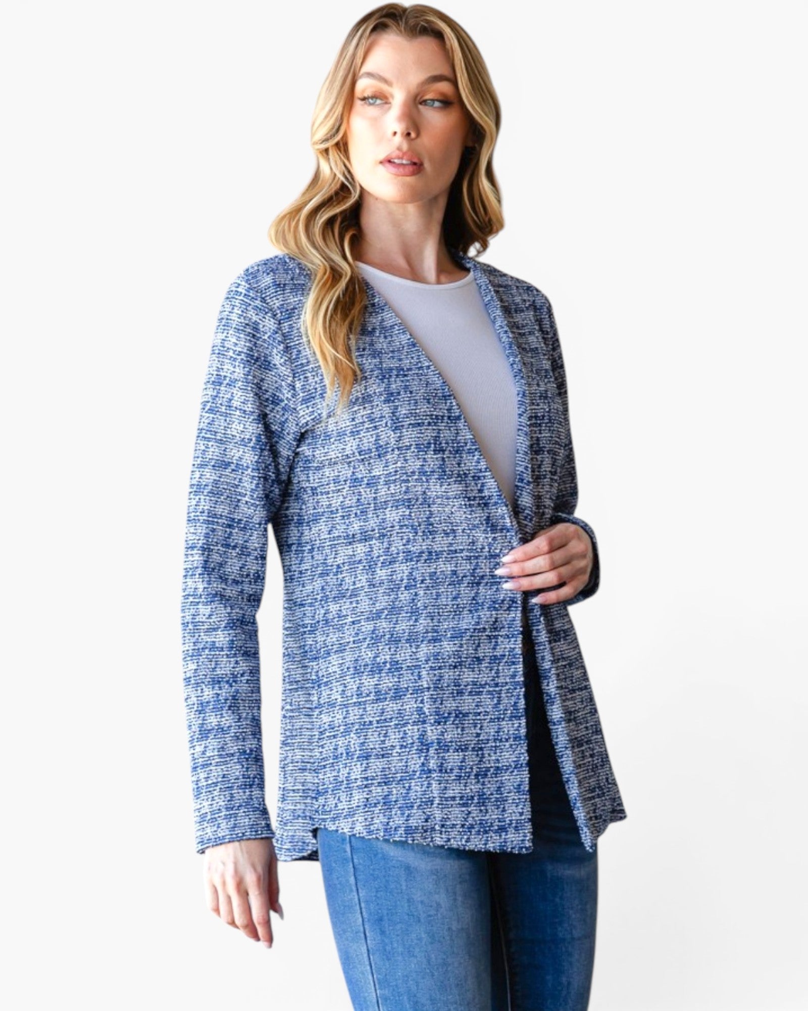 A woman modeling a blue and white textured tweed open-front cardigan over a light gray top and blue jeans, set against a plain white studio background.
