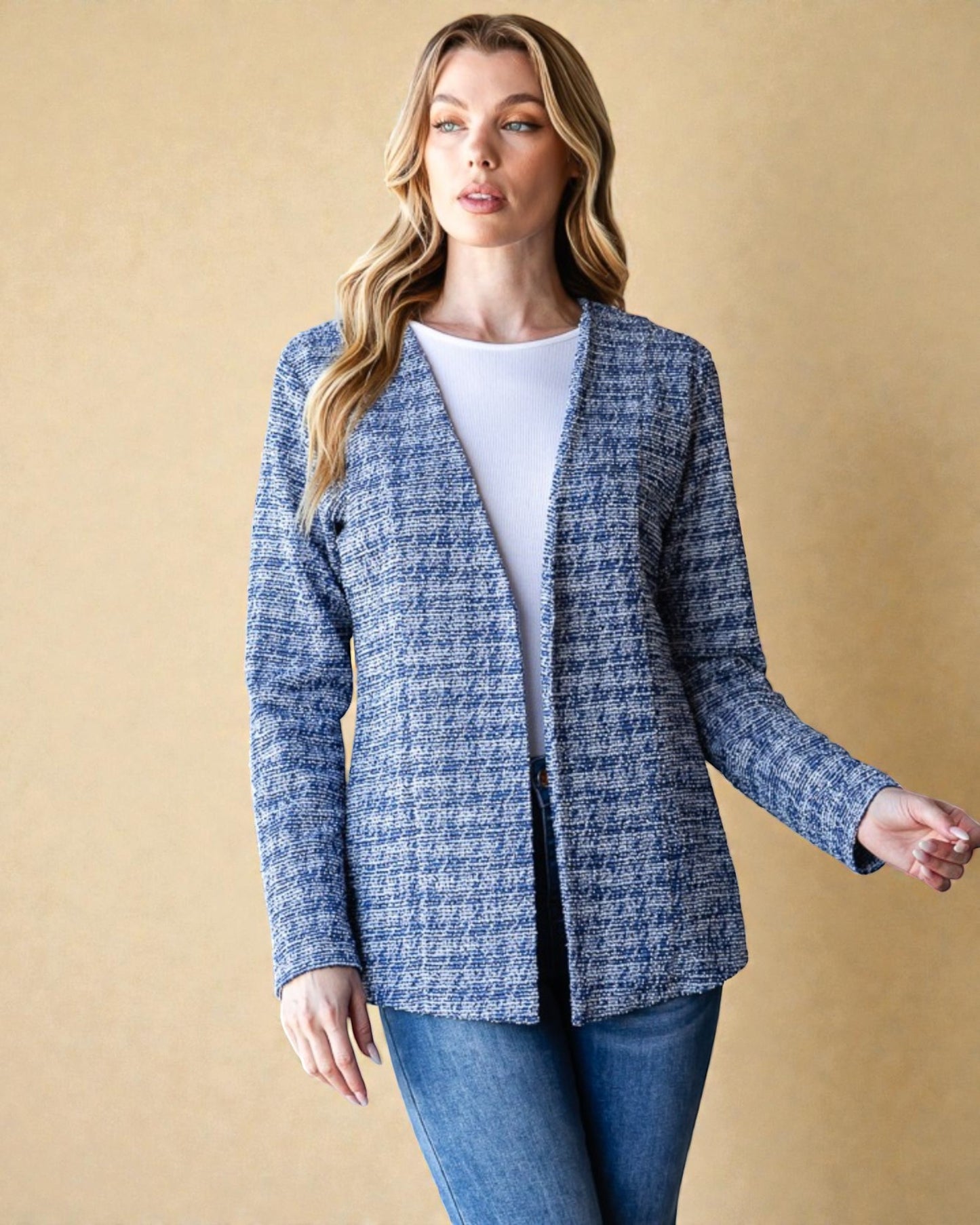 Woman wearing a blue checkered jacket against a beige background