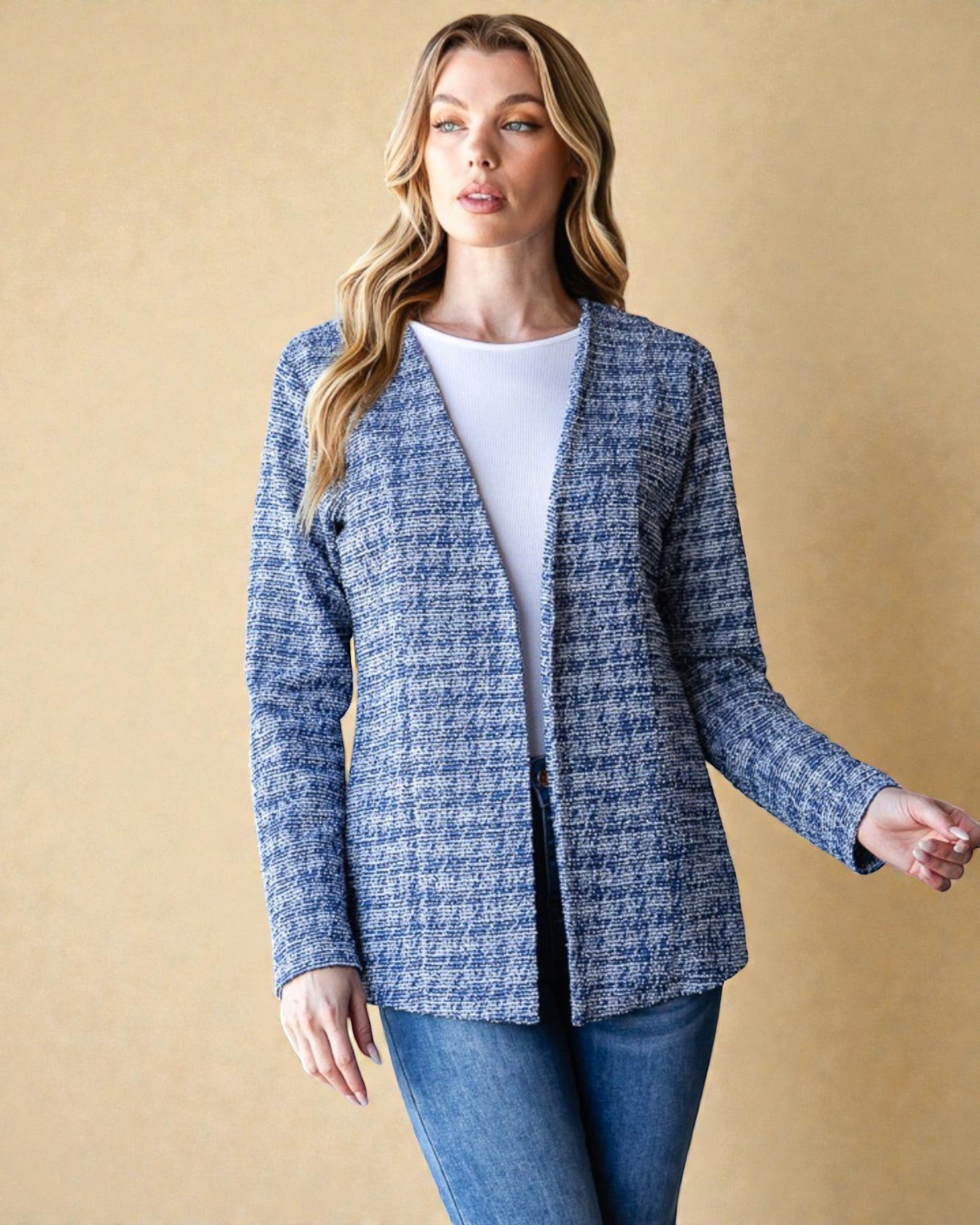 Woman wearing a blue checkered jacket against a beige background