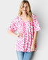 Woman wearing a pink leopard print top against a white background