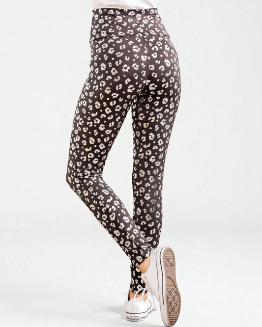 Black leggings with white leopard print worn by a person on a white background