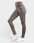 Person wearing black leggings with white leopard print pattern on a white background