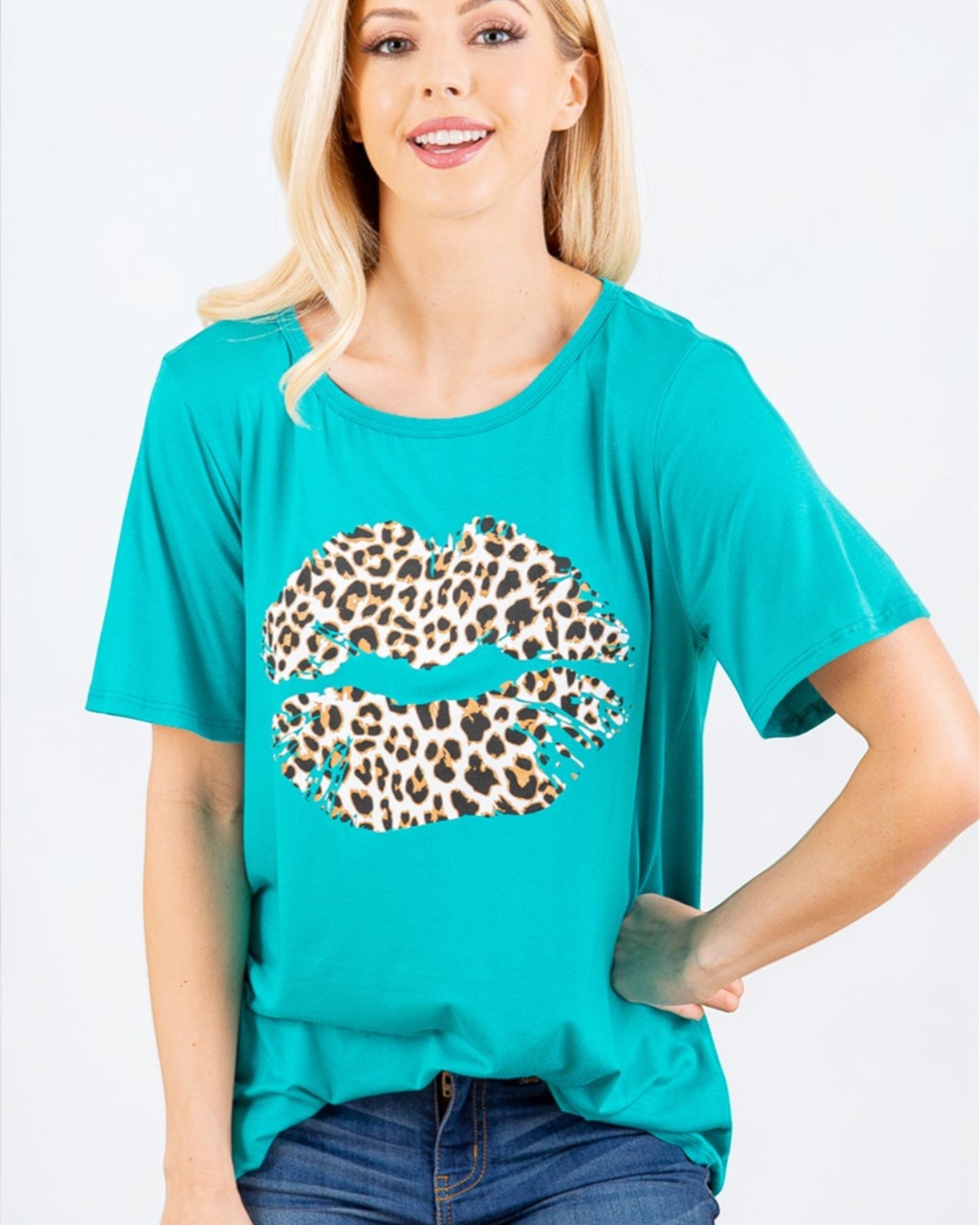 Woman wearing a teal t-shirt with a leopard print graphic on a white background