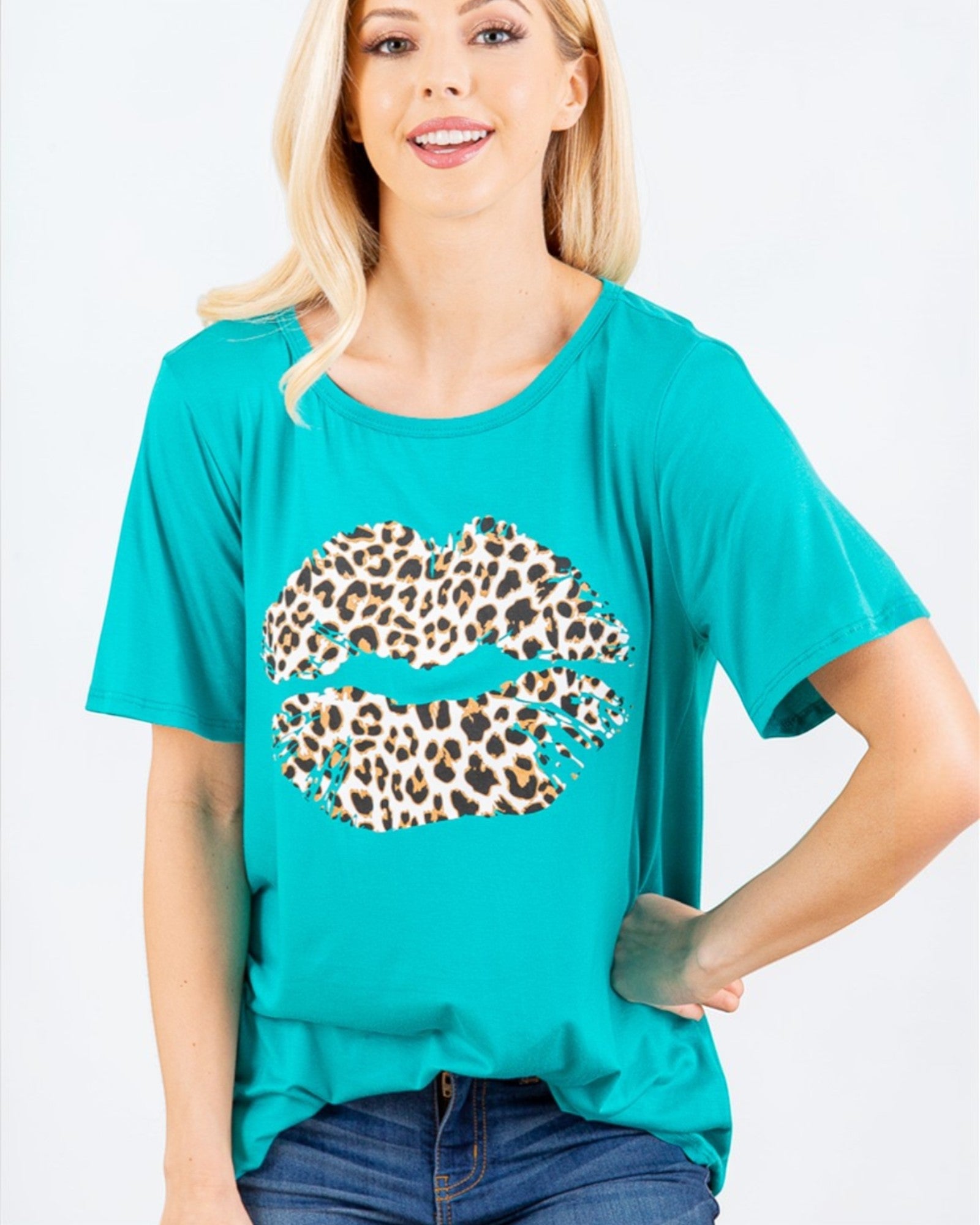 Woman wearing a teal t-shirt with a leopard print graphic on a white background