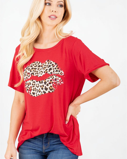Woman wearing a red t-shirt with a leopard print lip design on a white background