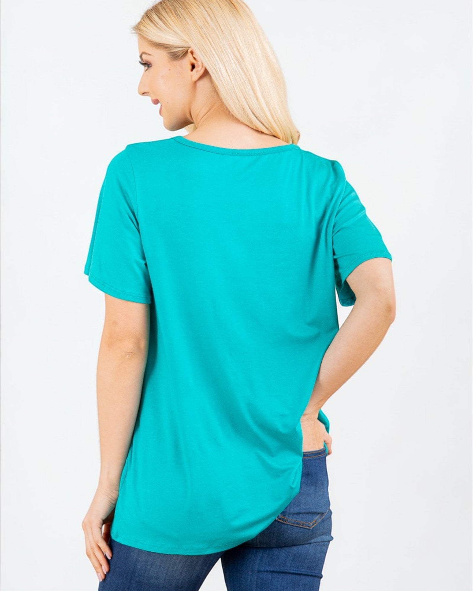 Woman wearing a teal t-shirt on a white background