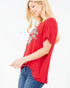 Woman wearing a red t-shirt with a leopard print design on a white background