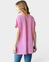 Woman wearing a pink ribbed sweater on a white background