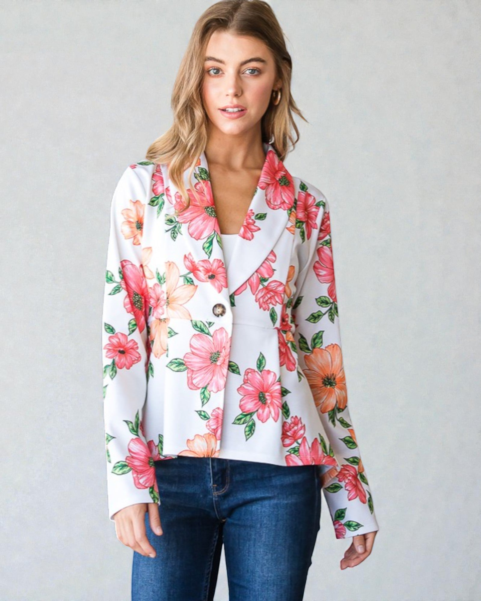 Woman wearing a floral jacket with a plain background