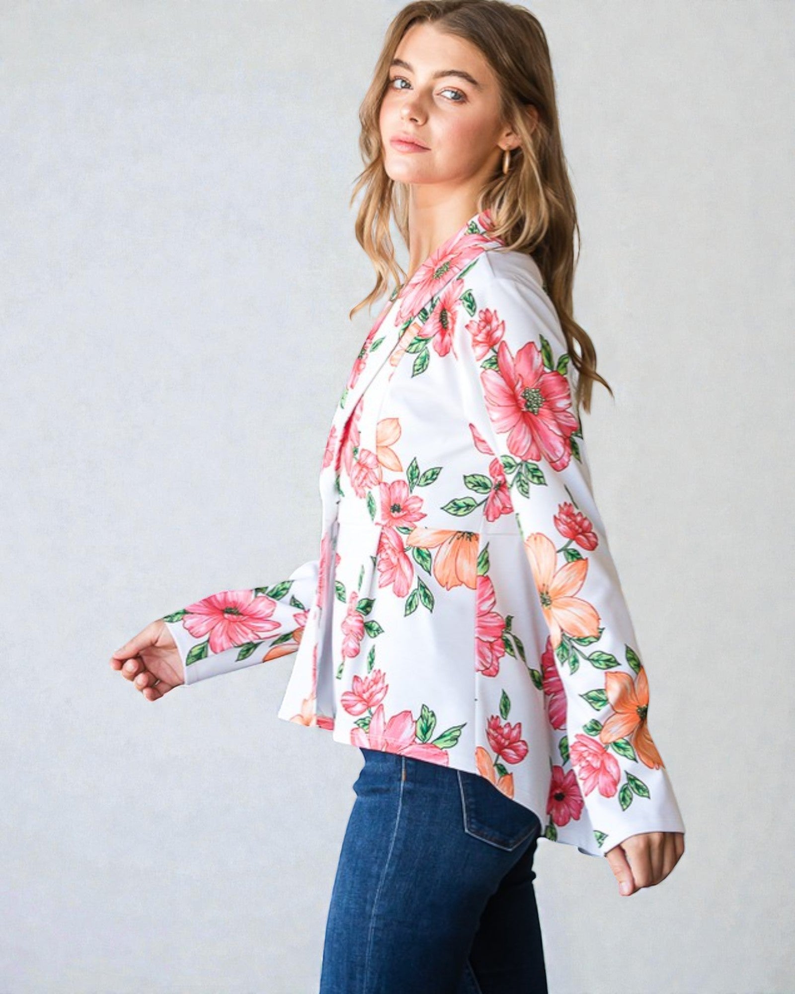 Woman wearing a floral blouse with a plain background