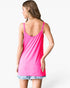 A woman shown from the back wearing a bright pink ribbed tank top and light blue denim shorts against a plain white background.