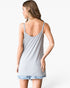 A woman shown from the back wearing a light gray ribbed tank top and light blue denim shorts with frayed hems, against a plain white studio background.