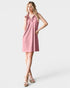 Woman wearing a pink dress on a white background
