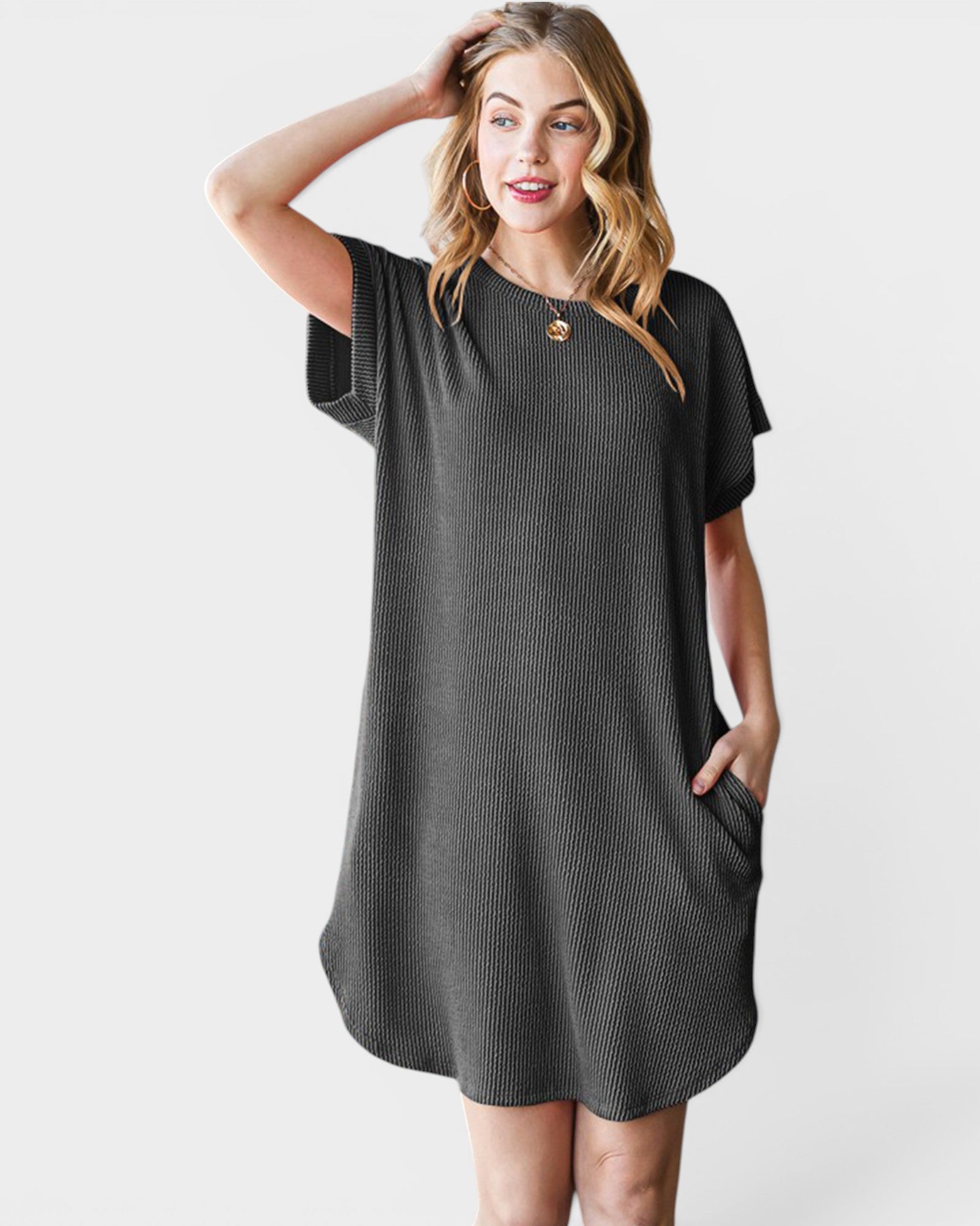 Woman wearing a black textured dress on a white background